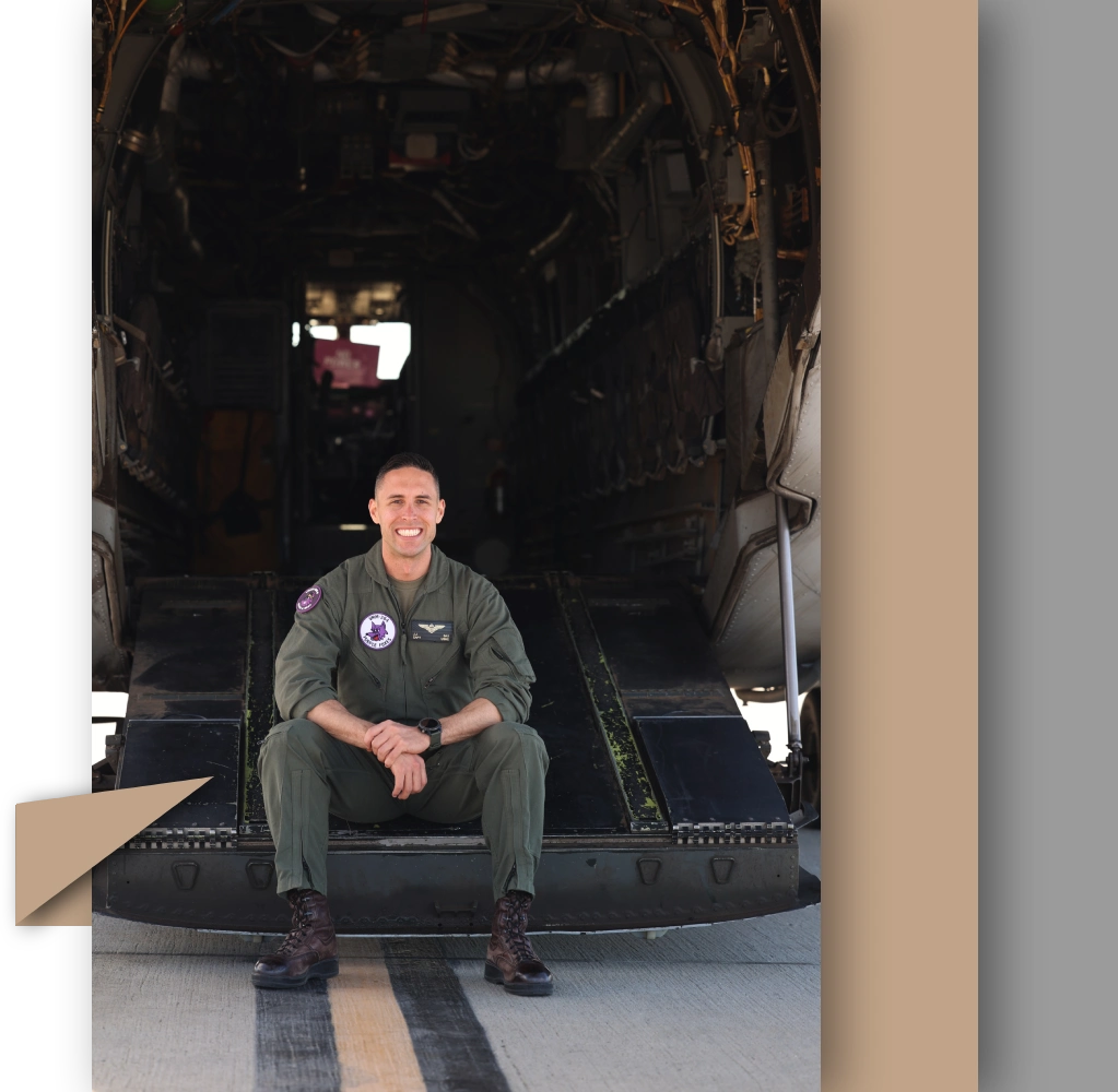 A man in uniform sitting on the ground.