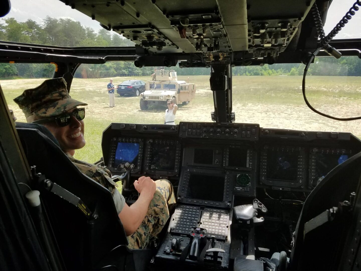 A man in the cockpit of an army helicopter.