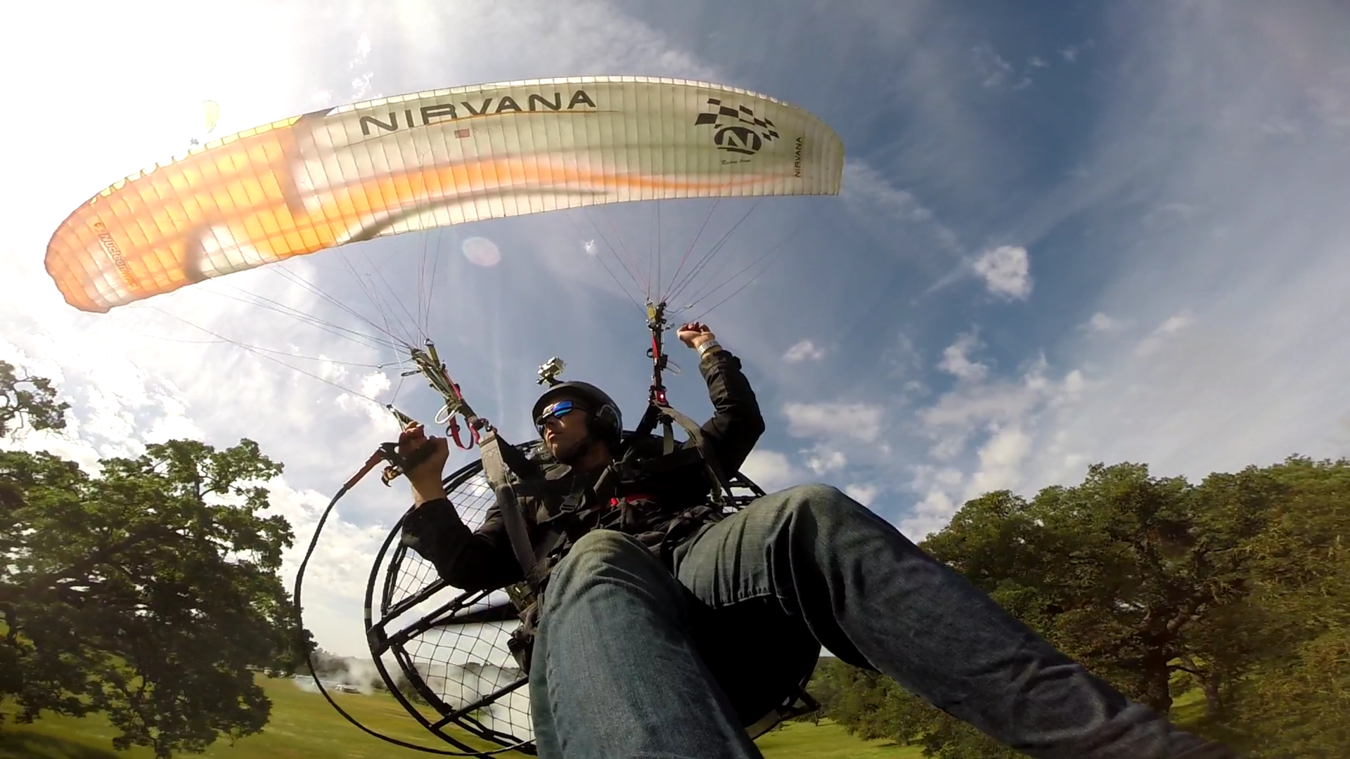 A man flying a para sail boat in the sky.