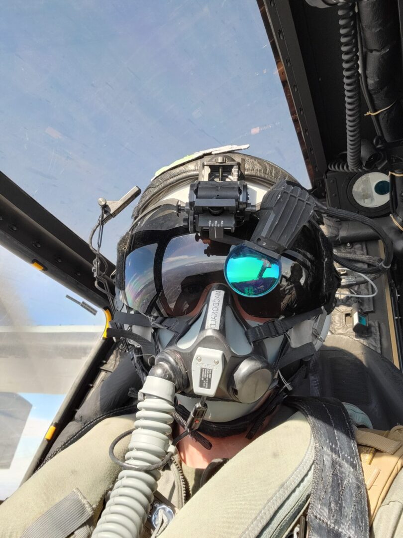 A pilot in the cockpit of an aircraft.