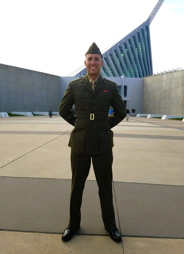 A man in uniform standing outside of a building.