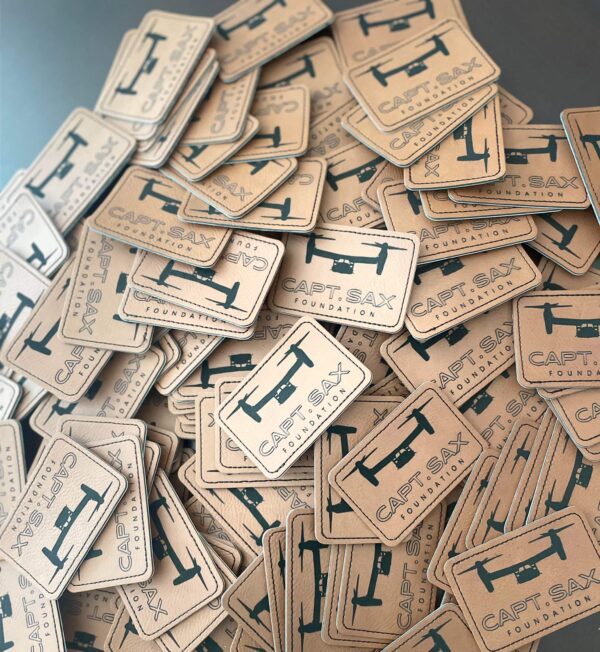 A pile of wooden tags with the letters i and j on them.