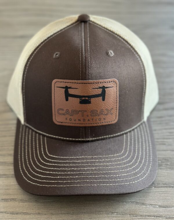 A brown and white hat with a patch on it