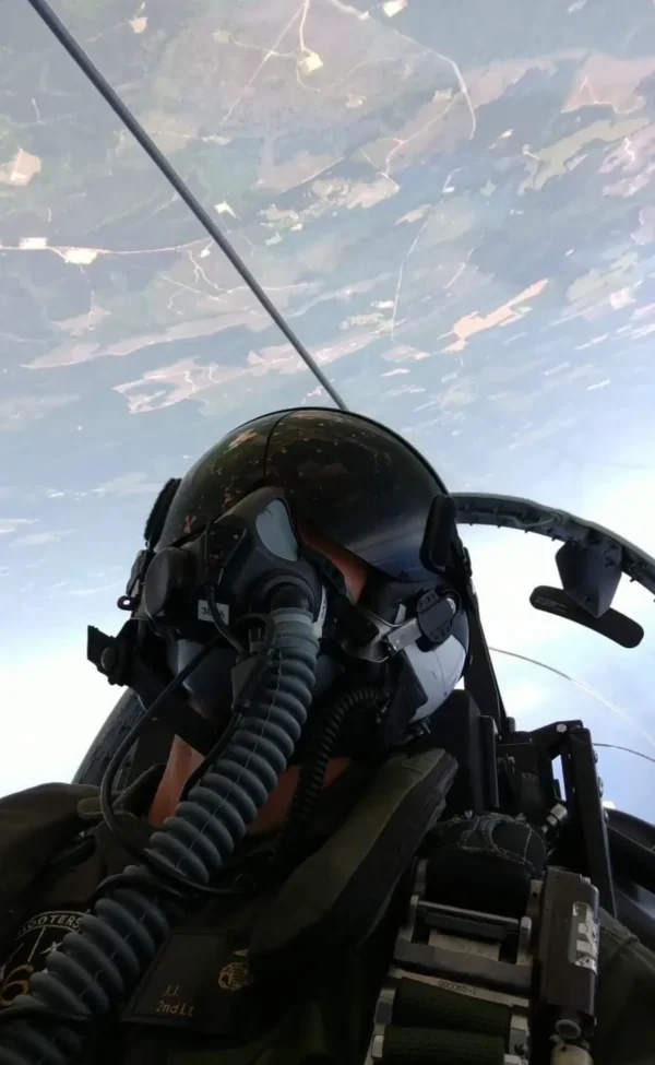 A fighter jet pilot is flying in the sky.