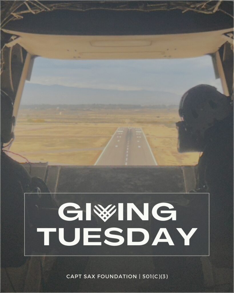 View from a helicopter cockpit over a runway with Giving Tuesday text.